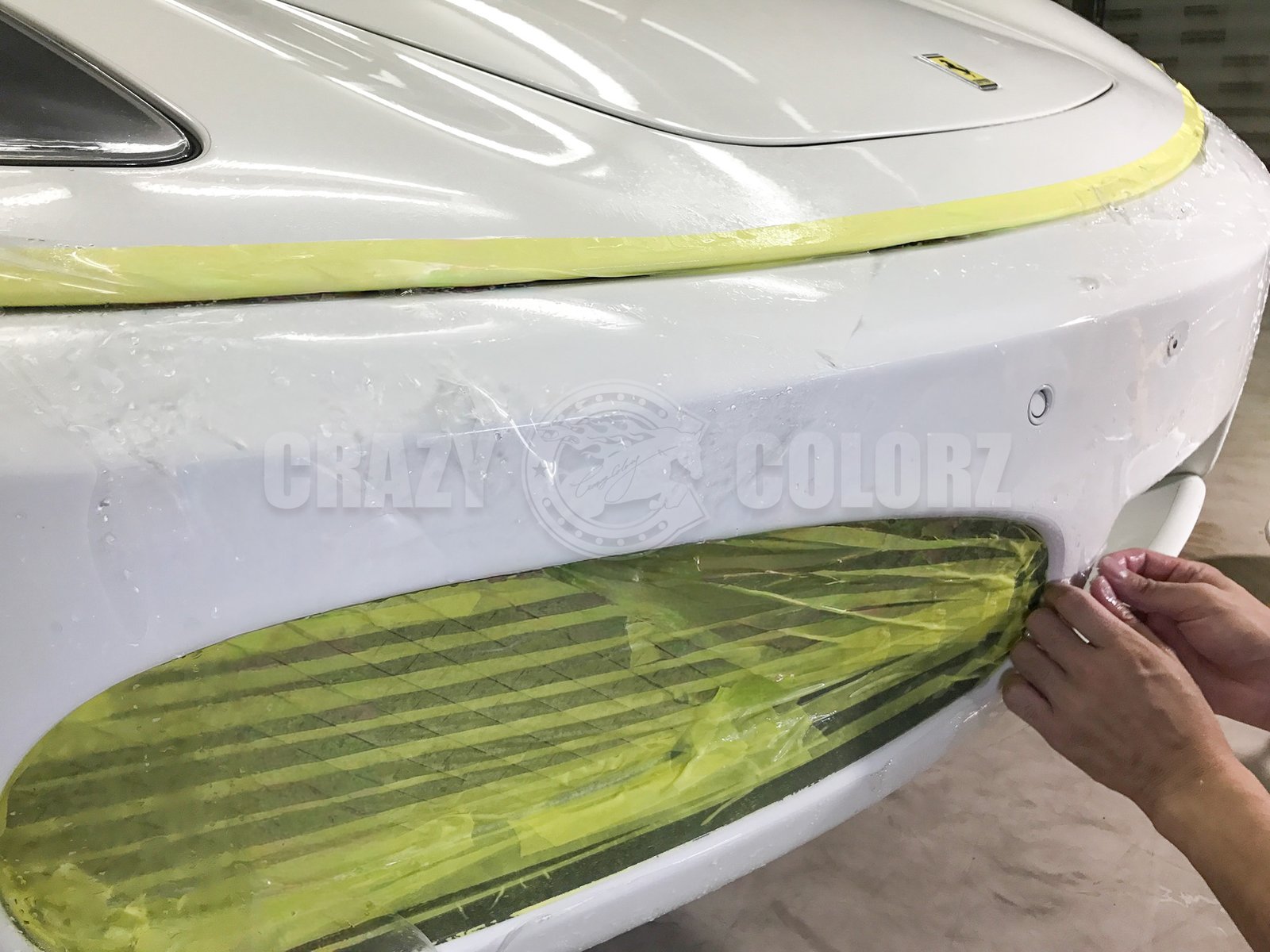 フェラーリ F430 Spiderのフロントバンパーへプロテクションフィルムを施工している様子
